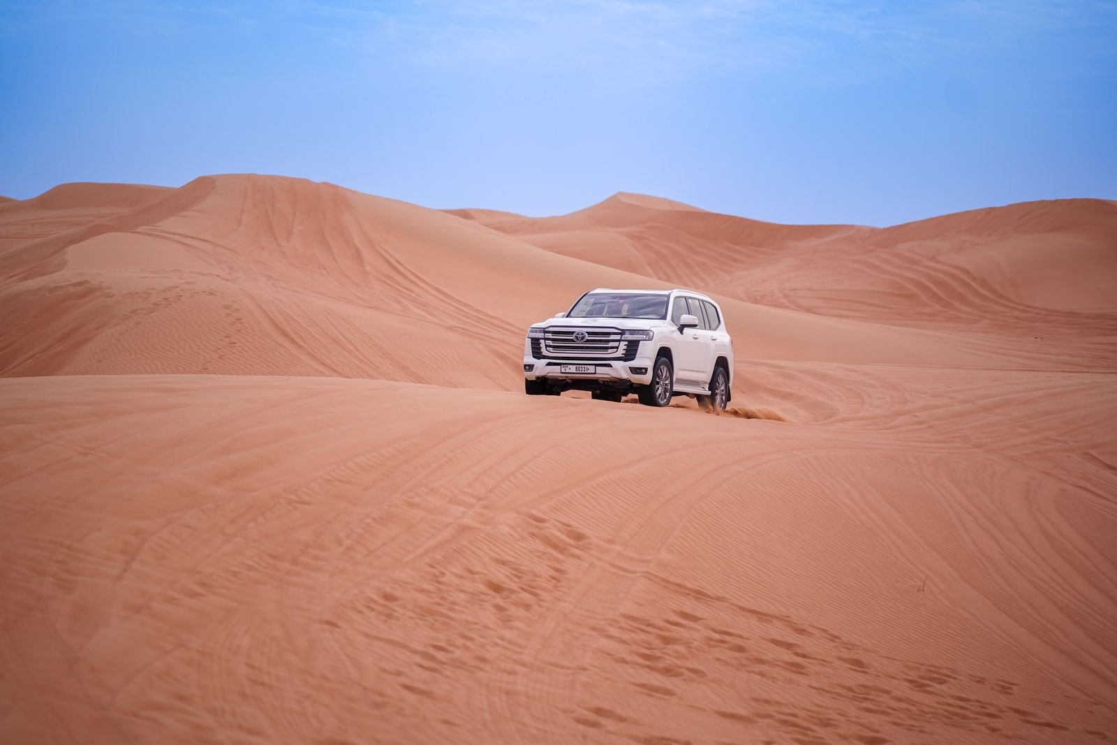 White Toyota Land Cruiser 4x4 on the desert dunes during a jeep safari from Hurghada