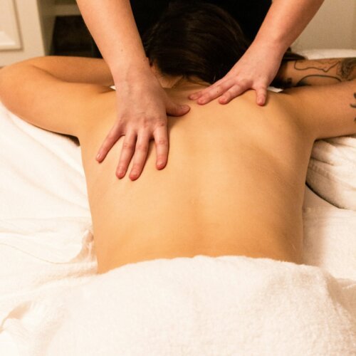 A woman getting a relaxing back massage at a spa