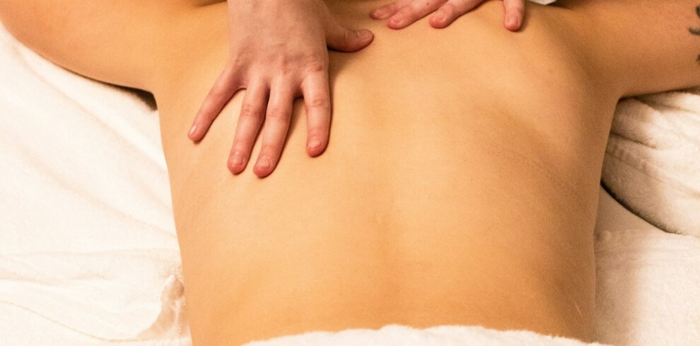 A woman getting a relaxing back massage at a spa